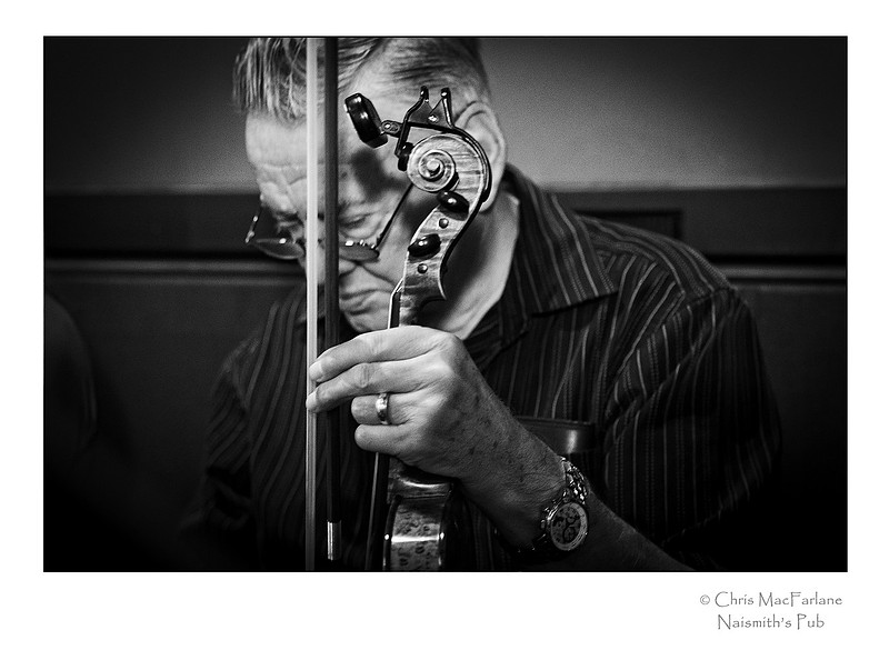 The Fiddler. A portrait of a fiddler a small town pub. Almonte, Ontario, Canada